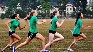 four girls running in a race.