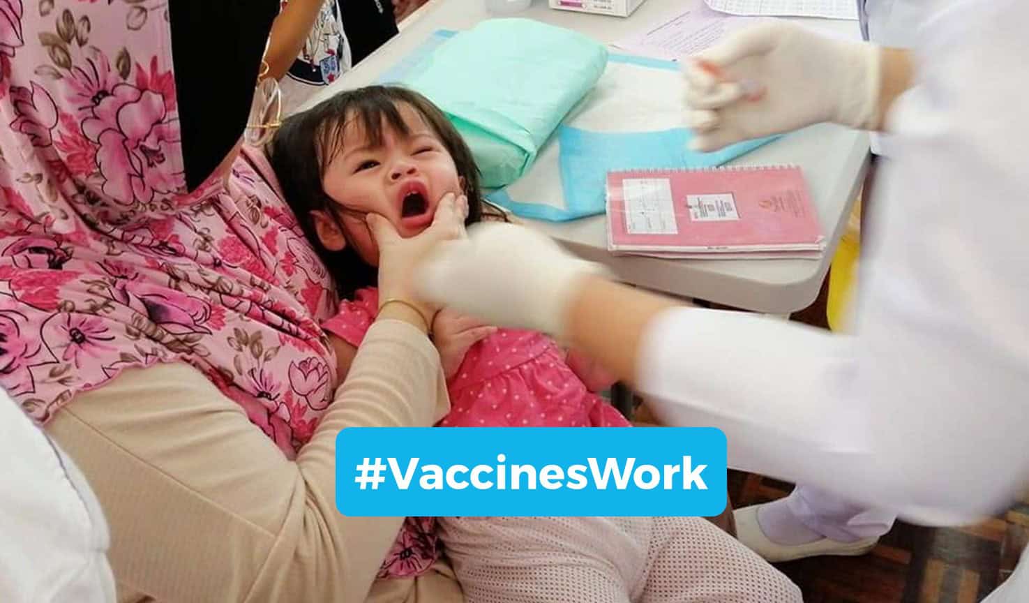 A young girl is immunised by a nurse from the Ministry of Health