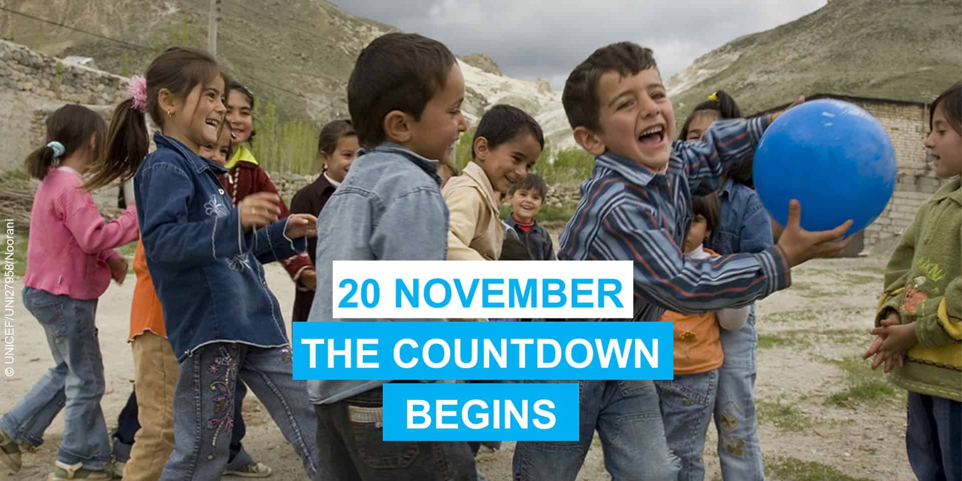 a group of children playing in a village. One boy is holding a blue ball. On the photo are the words 20 November. The countdown begins.