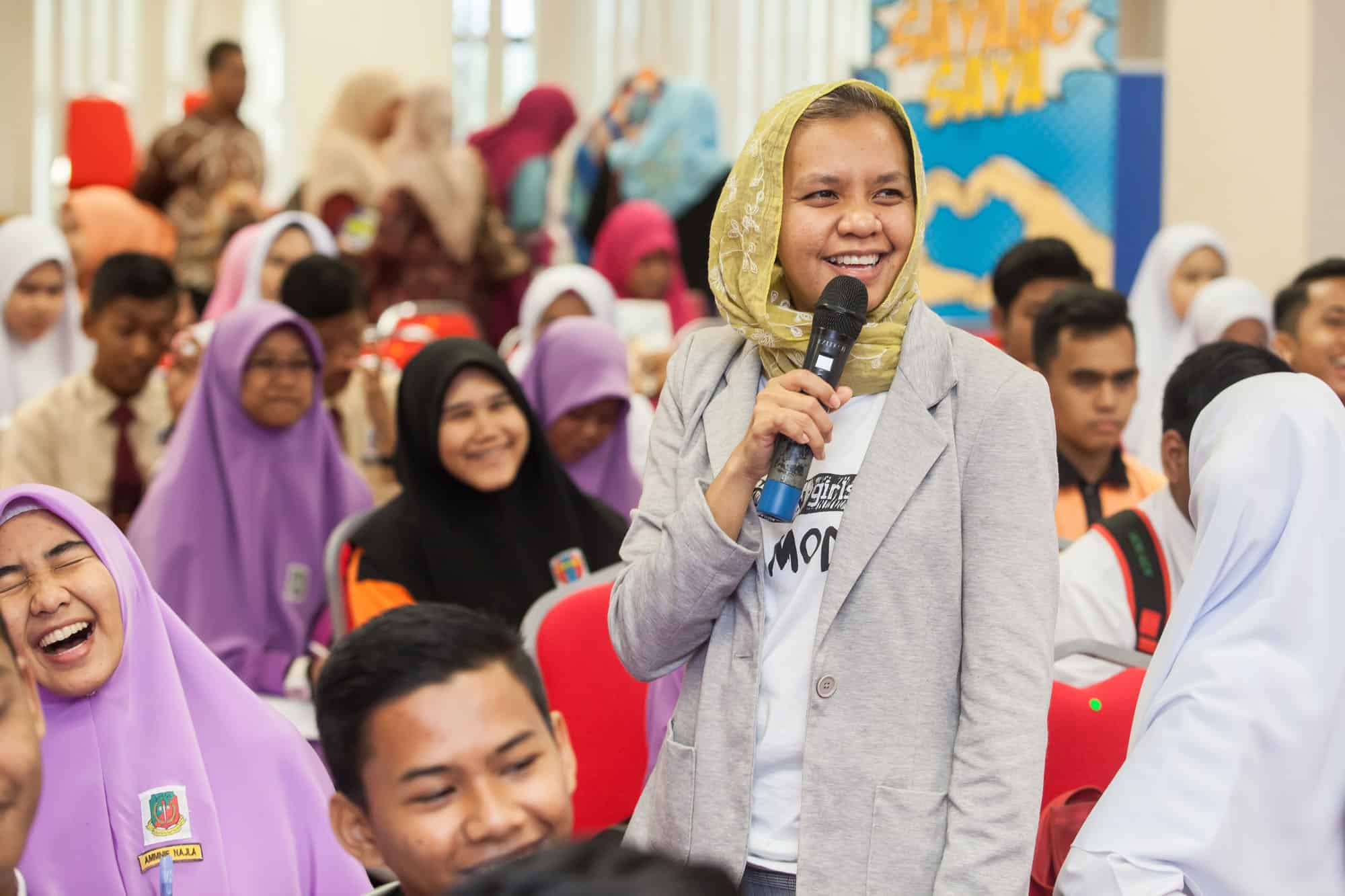 a townhall facilitator shares a joke with the students.