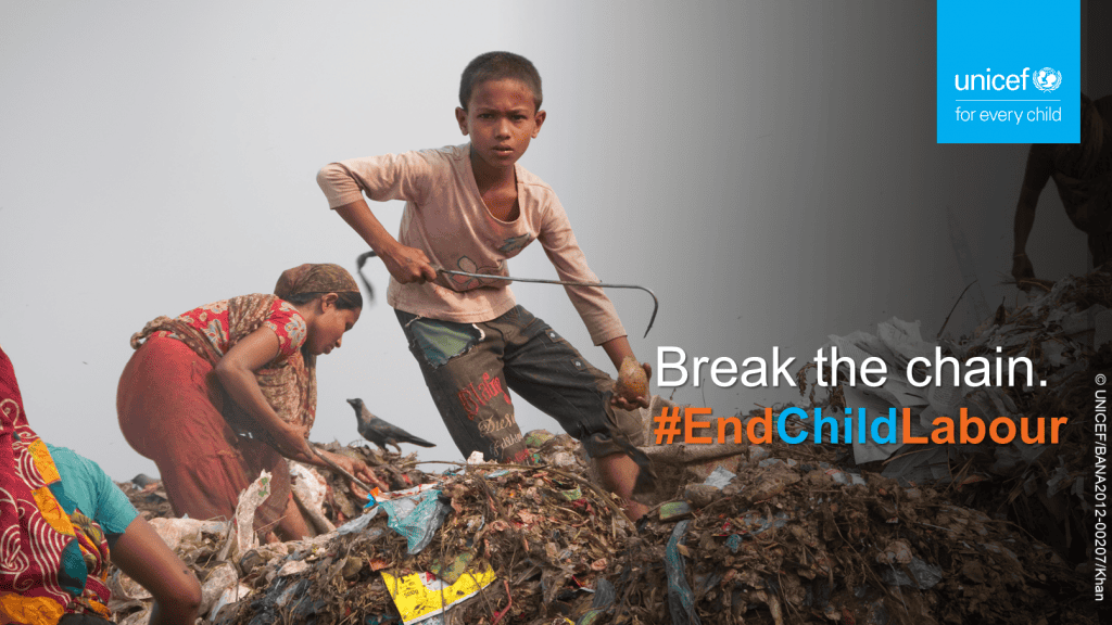 A child working at a garbage dumping site. A few women are working with him.