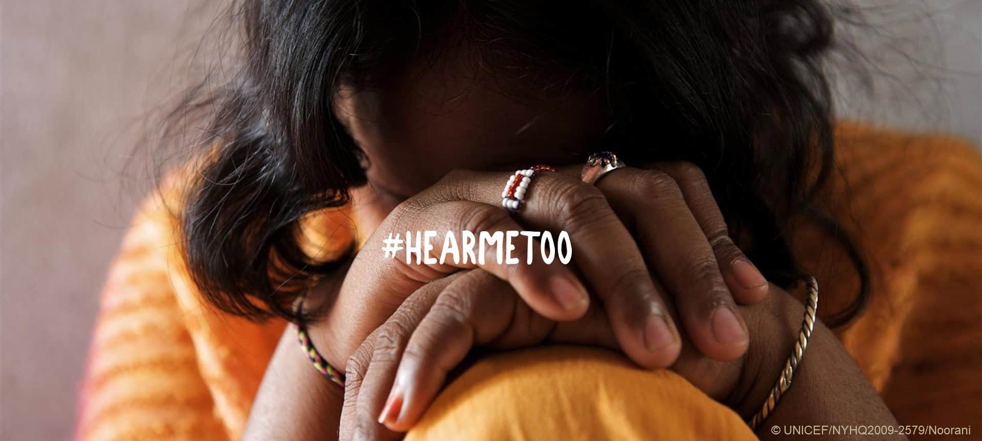 a woman sits with her head covered by her knees. The words "hear me too" are in the middle.