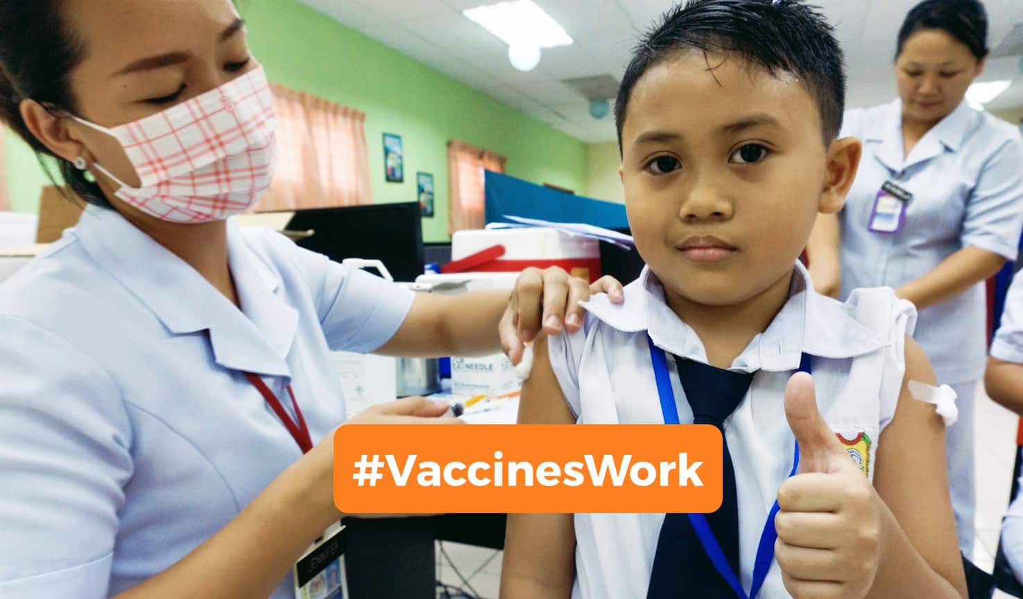 Boy receives a vaccine from a nurse.