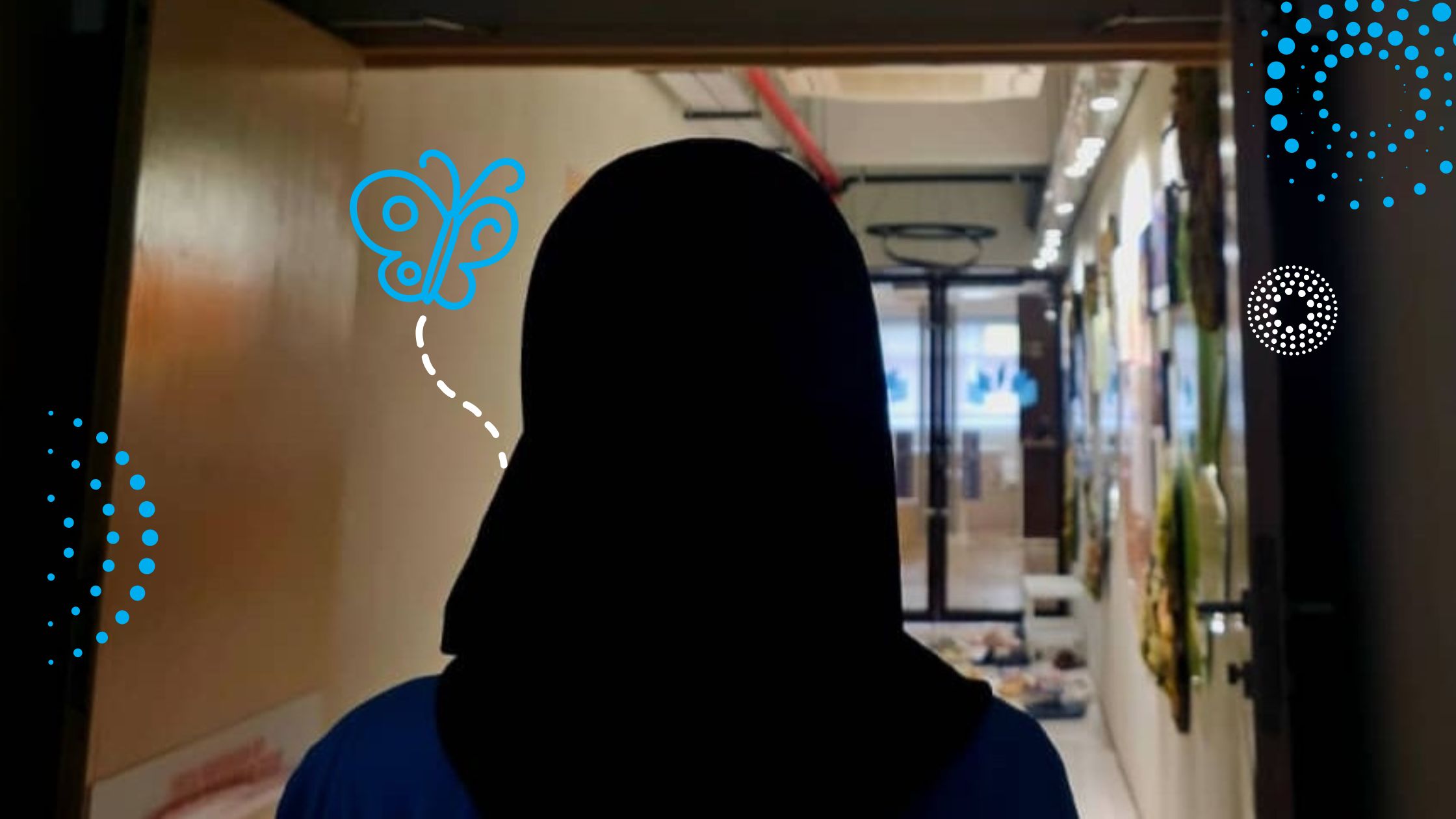 A silhouette of a young woman standing in a corridor.