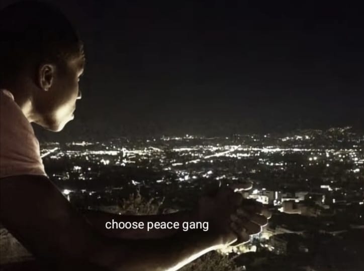 A young person looks out at the skyline. Text says "Choose peace geng.