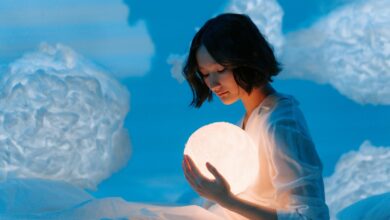 A girl holds a crystal ball.