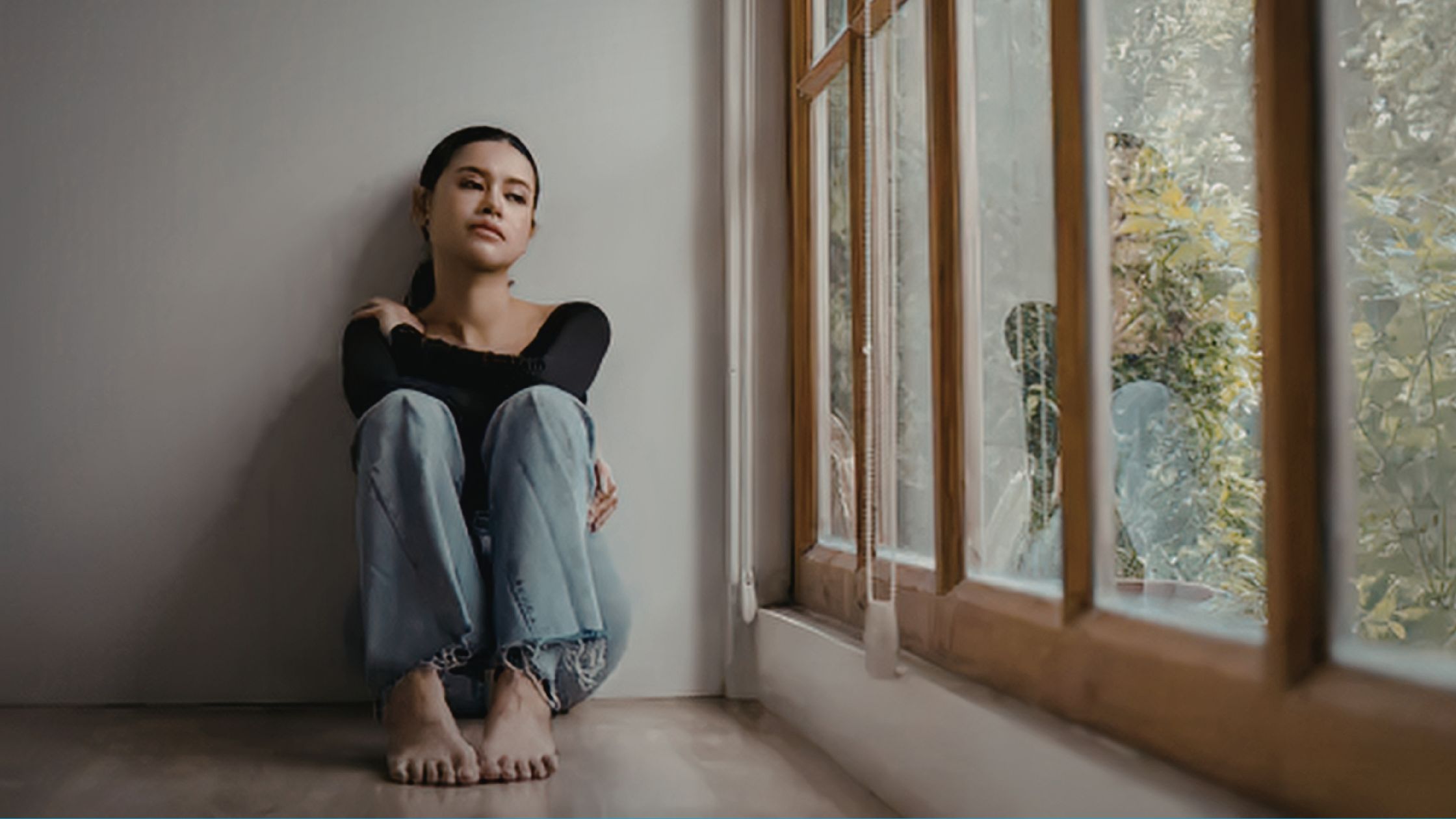 Young woman sitting by the window.
